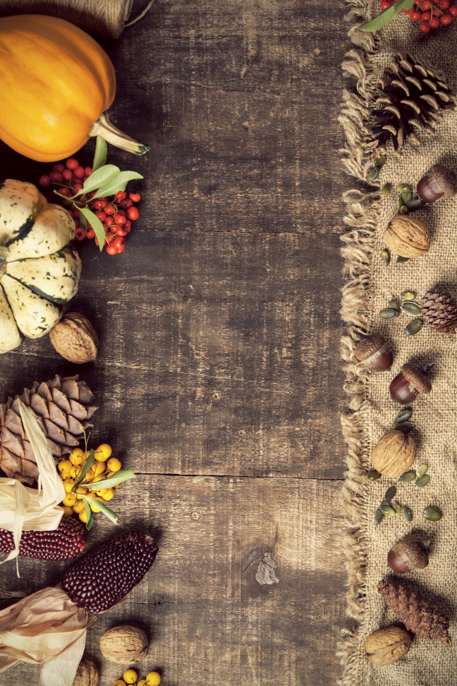 Autumn background - fallen leaves and healthy food on old wooden table. Thanksgiving day concept. Autumn background - fallen leaves and healthy food on old wooden table.