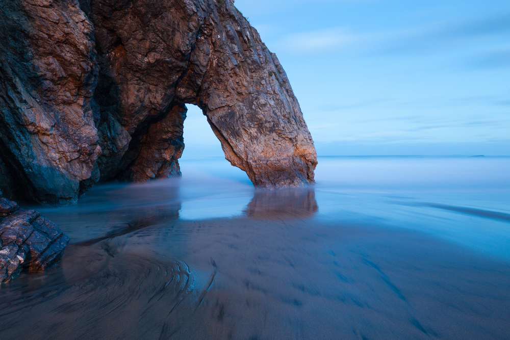Panoramic view of rocky arch at the Adraga beach, Portugal