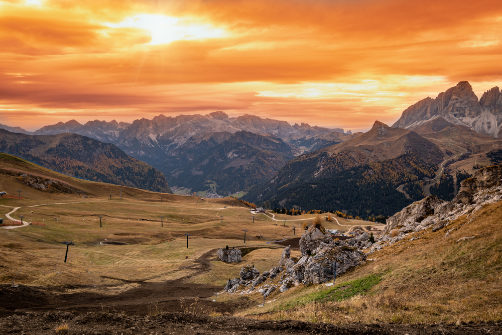 Autumn alpine Dolomites mountain dramatic sunset scene near Pordoi Pass, Trentino, Italy. Picturesque traveling, seasonal, nature and countryside beauty concept scene.
