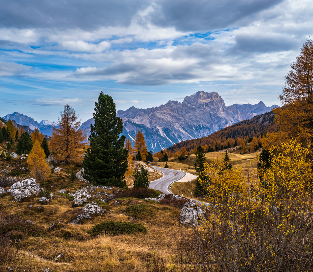 Morning autumn alpine Dolomites mountain scene. Peaceful view near Valparola and Falzarego Path, Belluno, Italy. Picturesque traveling, seasonal, nature and countryside beauty concept scene.