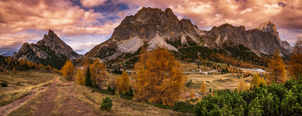 Colorful autumn alpine Dolomites rocky  mountain scene, Sudtirol, Italy. Peaceful view from Falzarego Path. Picturesque traveling, seasonal, nature and countryside beauty concept scene.