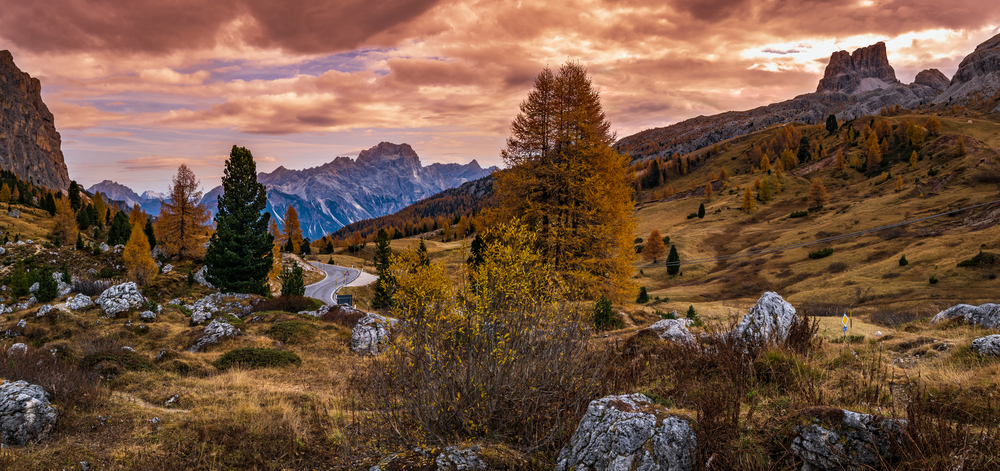 Overcast morning autumn alpine Dolomites mountain scene. Peaceful view near Valparola and Falzarego Path, Belluno, Italy. Picturesque traveling, seasonal, nature and countryside beauty concept scene.