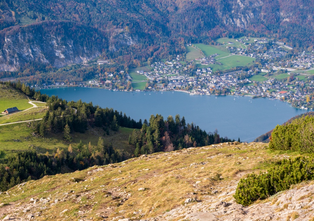 Picturesque autumn Alps mountain lakes view from Schafberg viewpoint, Salzkammergut, Upper Austria. People unrecognizable. Beautiful travel, hiking, seasonal, and nature beauty concept scene.