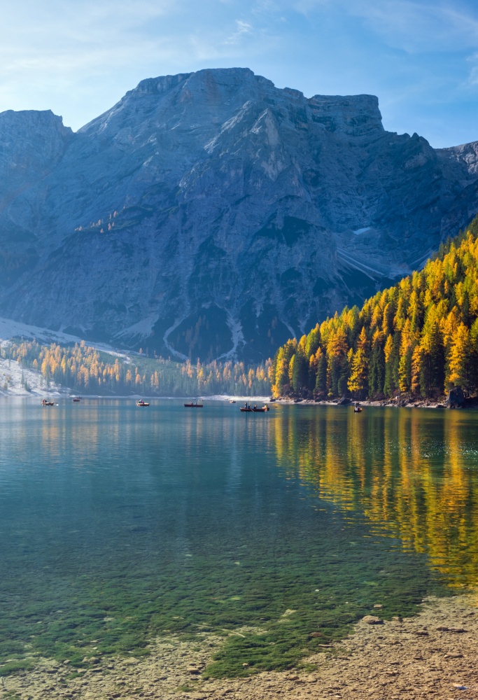 Autumn peaceful alpine lake Braies or Pragser Wildsee, South Tyrol, Dolomites Alps, Italy, Europe. Picturesque traveling, seasonal and nature beauty concept scene. People unrecognizable.