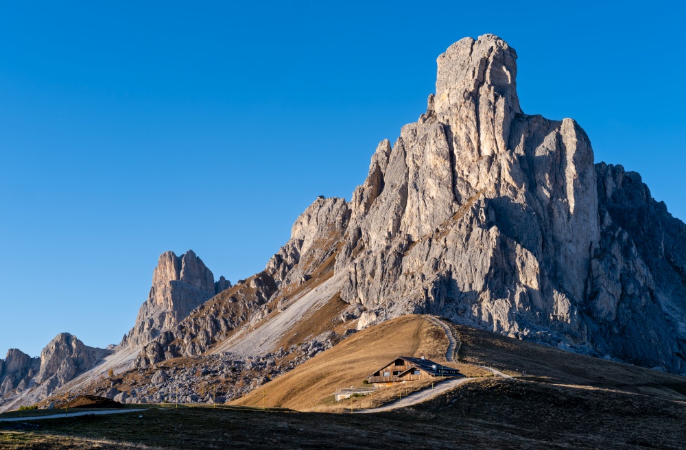 Italian Dolomites mountain (Ra Gusela rock in front) peaceful sunny evening view from Giau Pass. Picturesque climate, environment and travel concept scene.