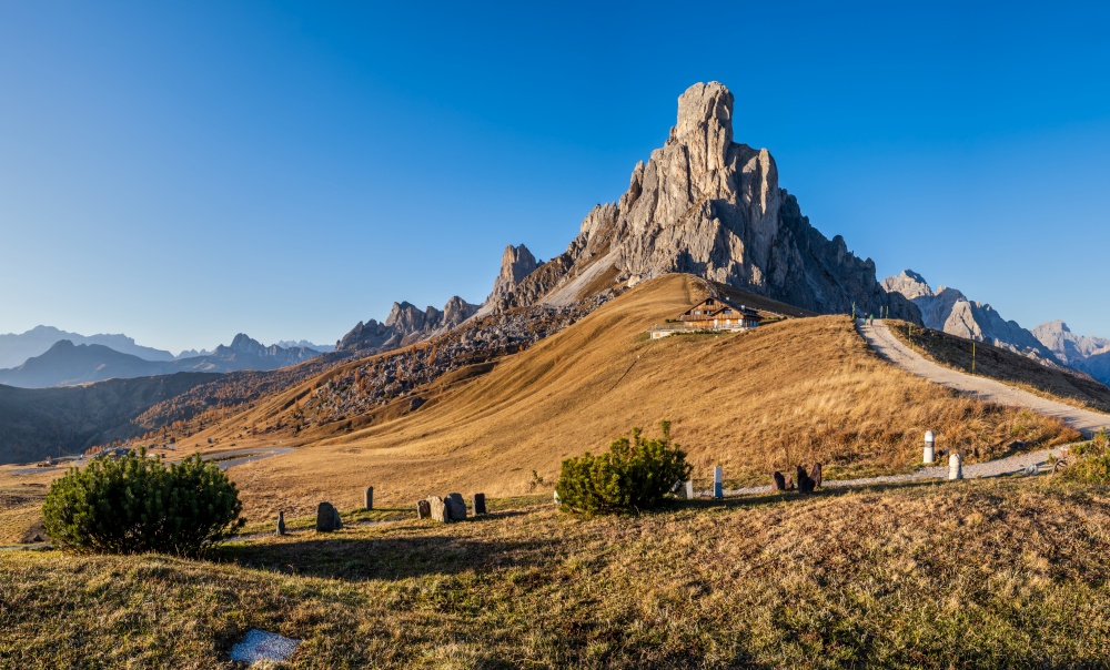 Italian Dolomites mountain (Ra Gusela rock in front) peaceful sunny evening view from Giau Pass. Picturesque climate, environment and travel concept scene. People unrecognizable.