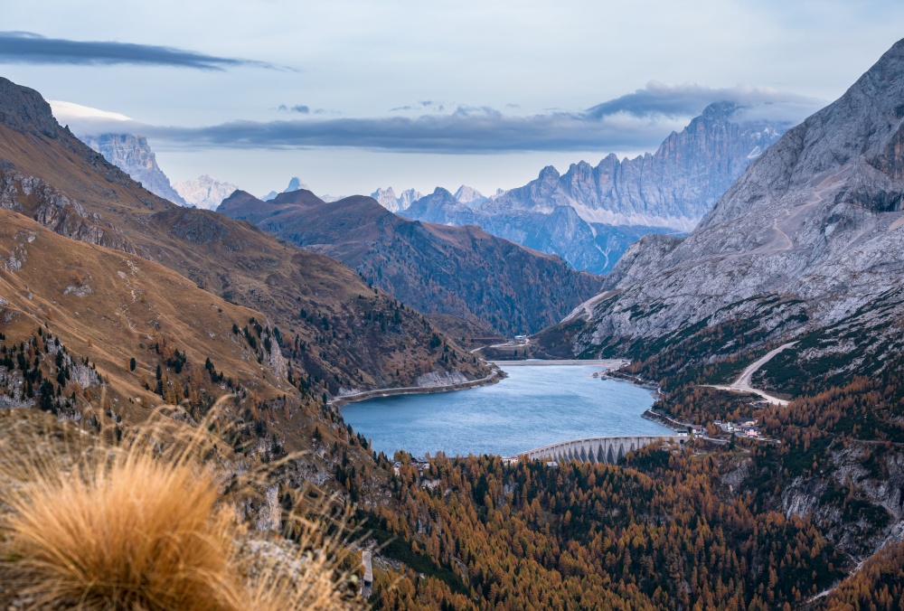 Autumn Dolomites mountain view from hiking path betwen Pordoi Pass and Fedaia Lake, Trentino, Italy. Picturesque traveling, seasonal, nature and countryside beauty concept scene.