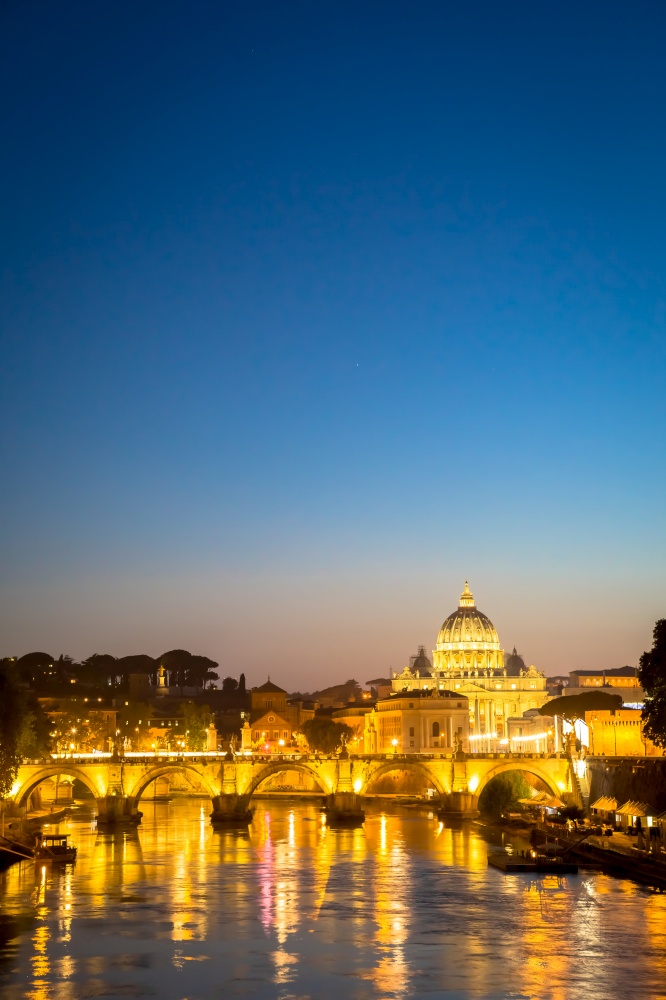 ROME, ITALY - JUNE 2020: sunset panorama on Tiber river bridge with Saint Peter Cathedral dome (Vatican City) in background - Rome, Italy
