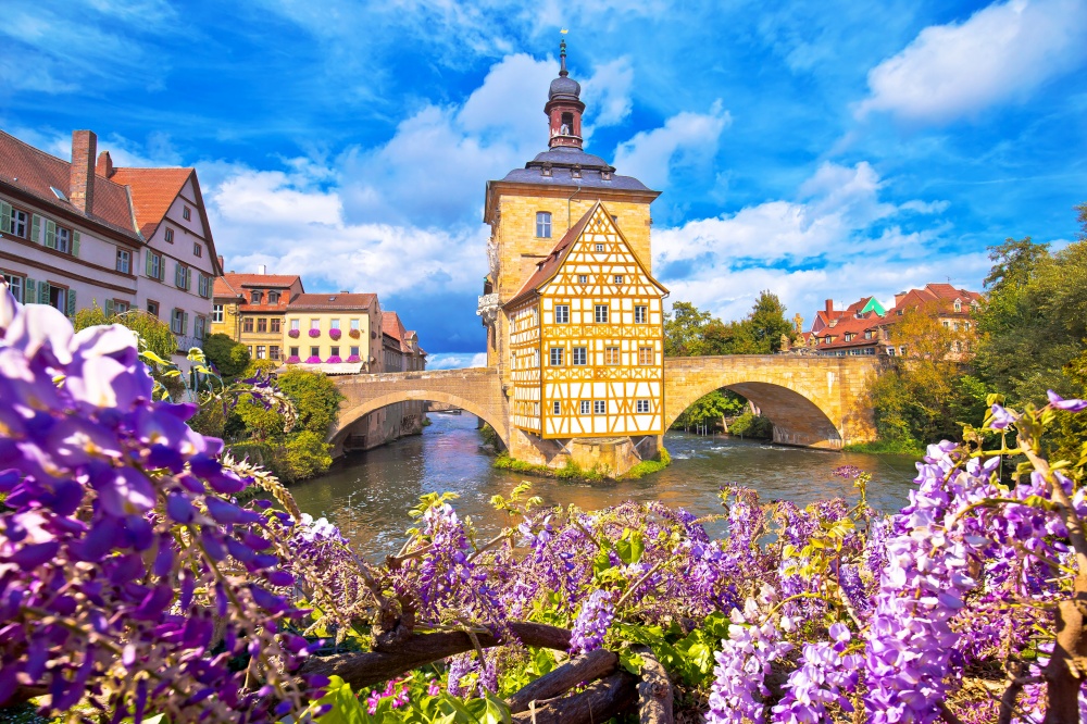 Scenic view of Old Town Hall of Bamberg (Altes Rathaus) with two bridges over the Regnitz river flower view,  Upper Franconia, Bavaria region of Germany