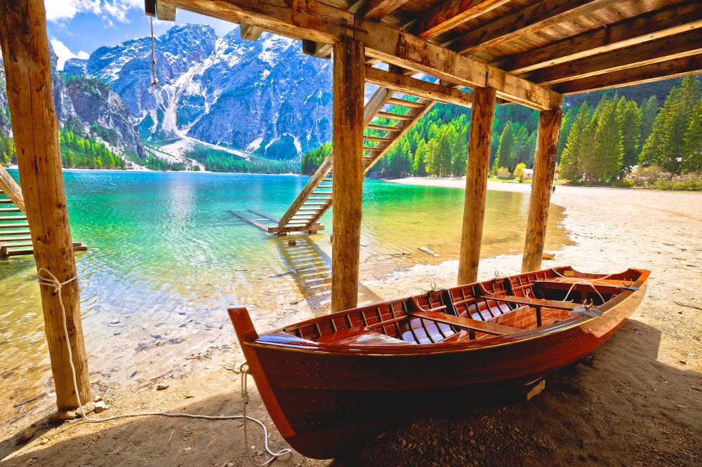 Wooden boat under boats house on Braies lake in alpine landscape, South Tyrol region of northern Italy