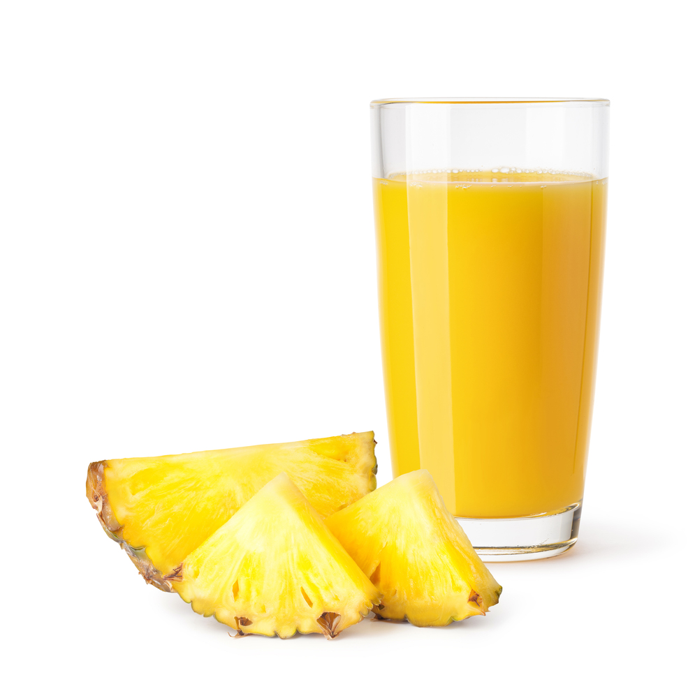glass of pineapple juice on a white background. glass of pineapple juice