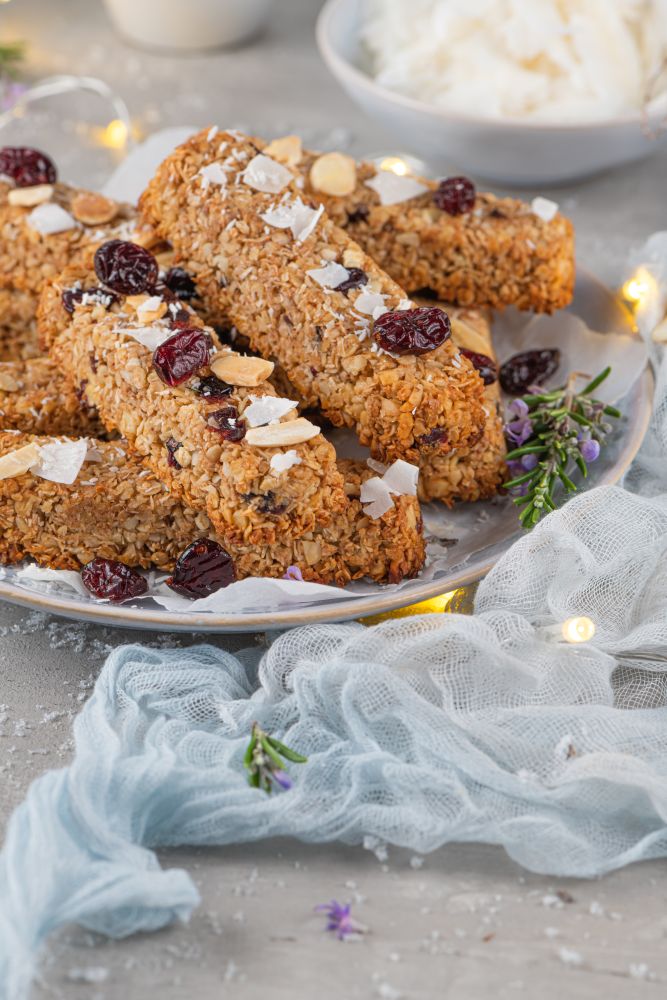 Granola bar. Healthy snack. Cereal granola bar with nuts, fruit, coconut and cranberries on a christmas table.