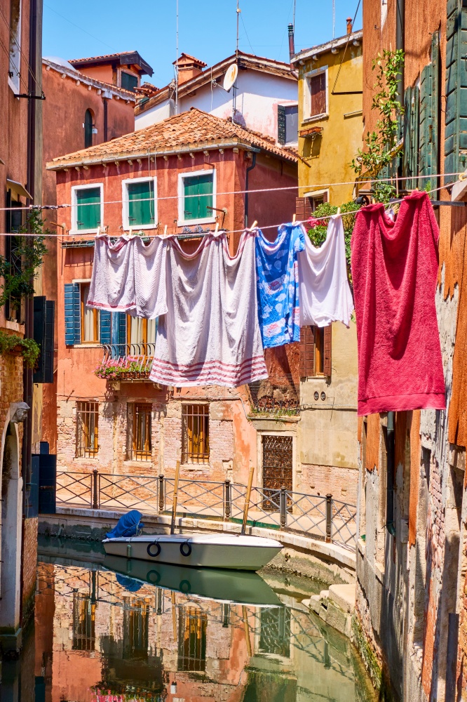 Picturesque view of small venetian canal and drying linen outdoor, Venice, Italy - Italian cityscape