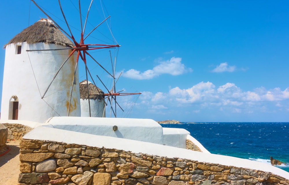 Old windmillls by the sea in Mykonos island, Greece. Greek scenery