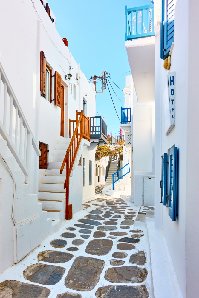 Perspective of old street with whitewashed houses in Mykonos, Greece - Greek cityscape