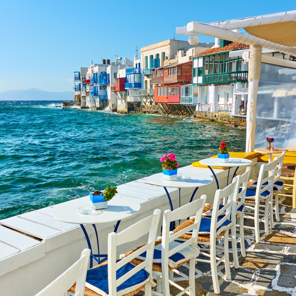 Open-air cafe near famous houses by the sea in Mykonos Island, Greece