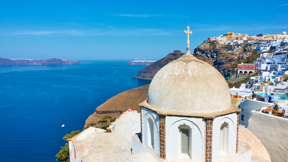 Panoramic view of Santorini island with ancient greek church on the coast in Fira (Thera) town, Greece